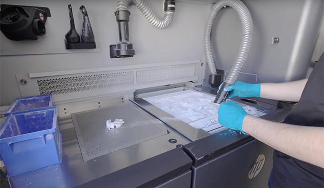 Man making 3D dental prints using HP 3D Printer